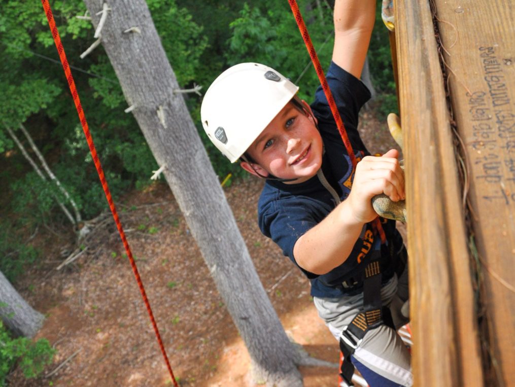 Young male climber on the rock tower on the Rock Climbing & Canoeing Pioneer Expedition