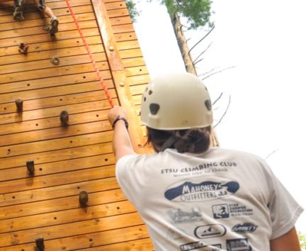 Staff belaying a climber on the Rock Climbing & Canoeing Pioneer Expedition