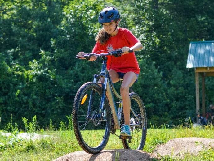 Girl mountain biking at camp
